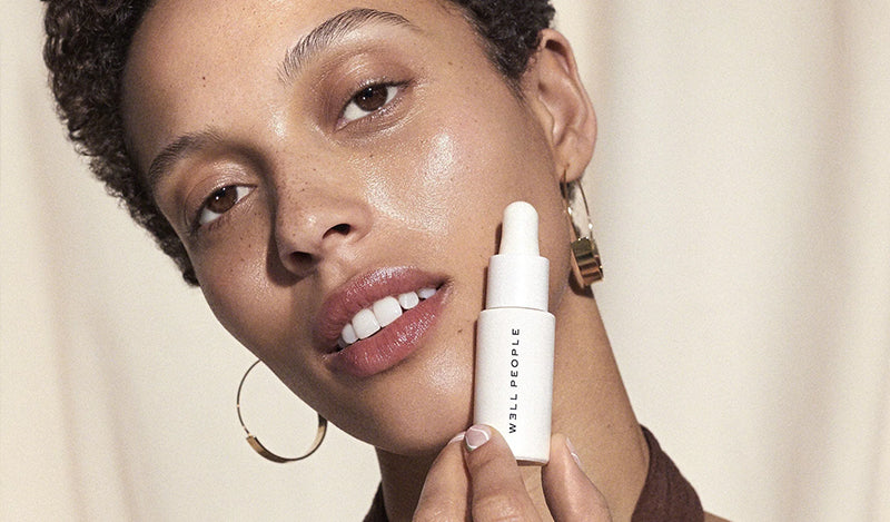 woman holding makeup skincare hybrid products