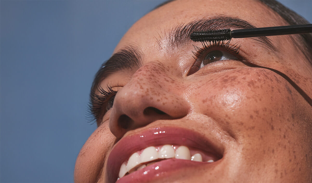 Woman applying curling mascara
