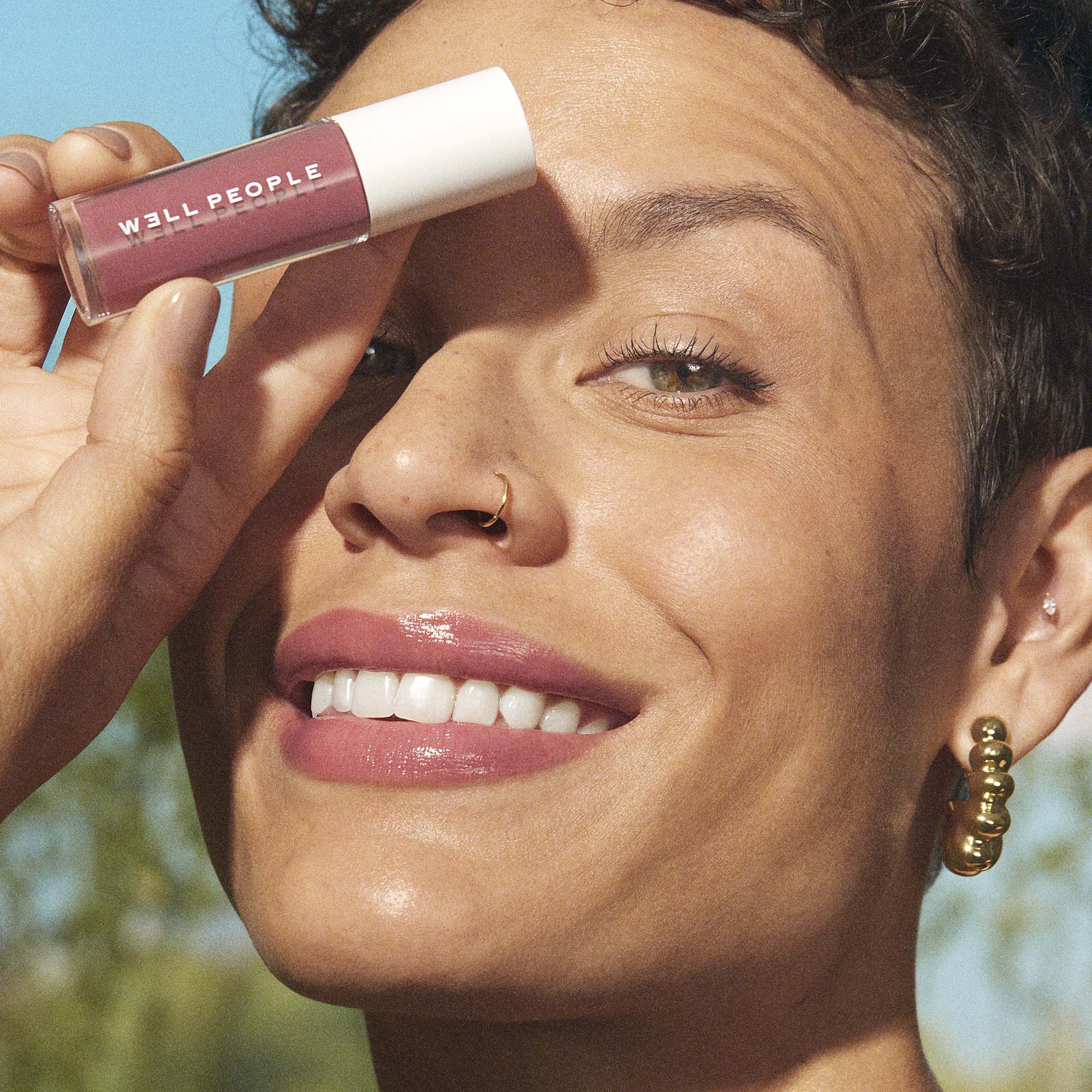 woman wearing neutral pink lip oil