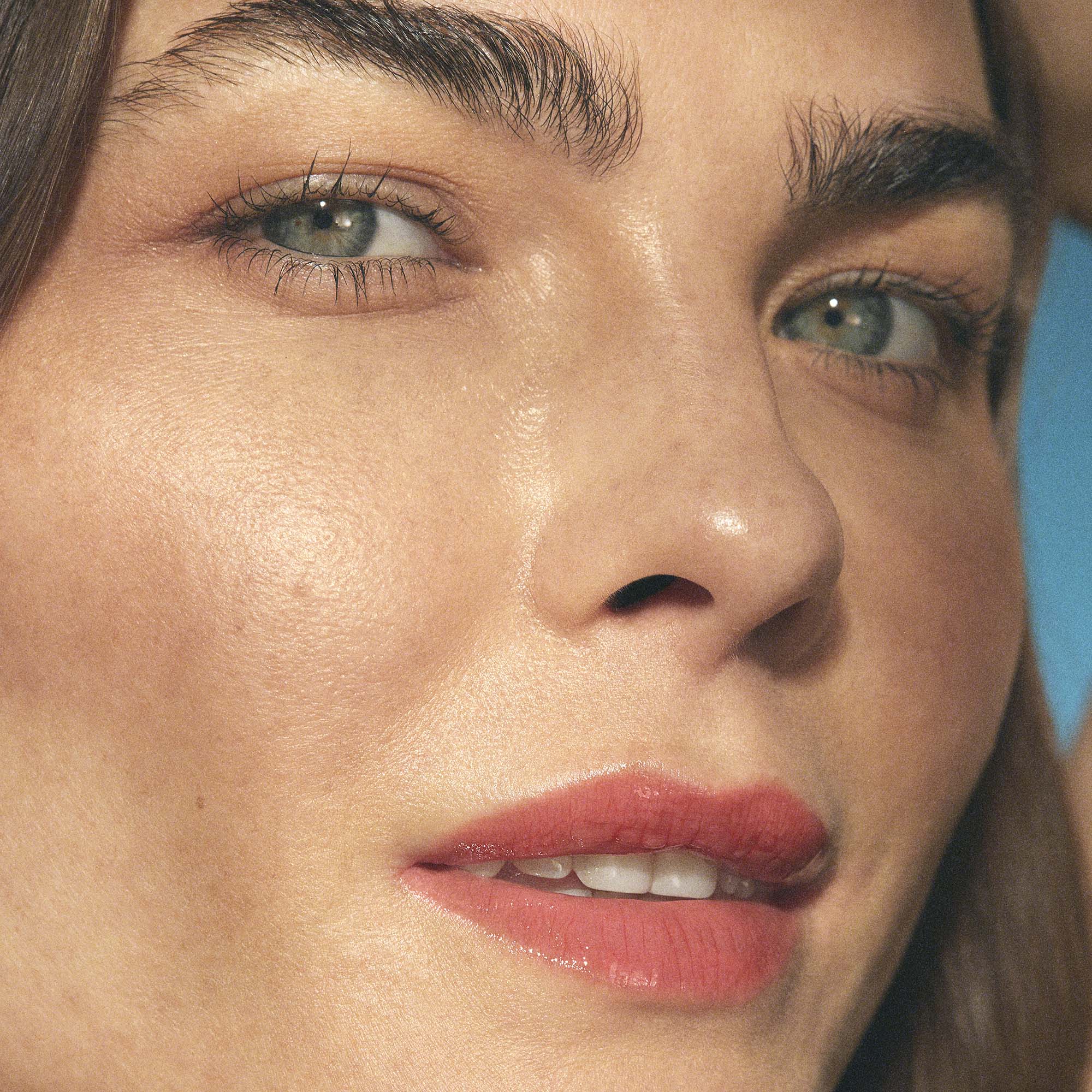 woman wearing coral red lip oil