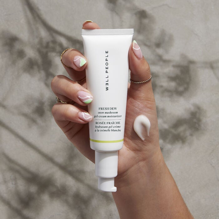 womens hand holding gel moisturizer