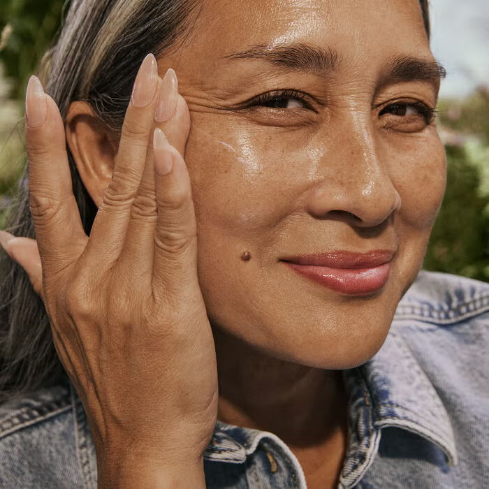 woman applying well people mineral sunscreen